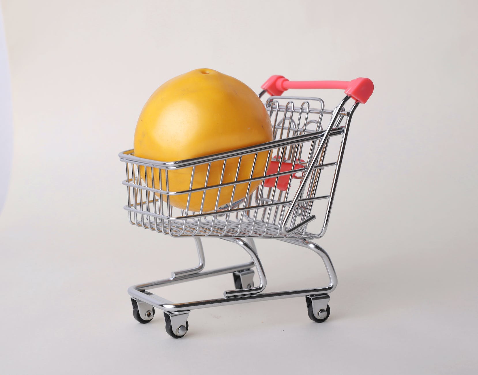 yellow round fruit on stainless steel shopping cart